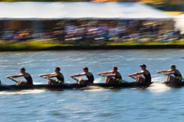 Six people rowing a boat